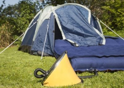 A footpump inserted into a camping airbed ready for inflation - focus on the pump.Related images in my portfolio: